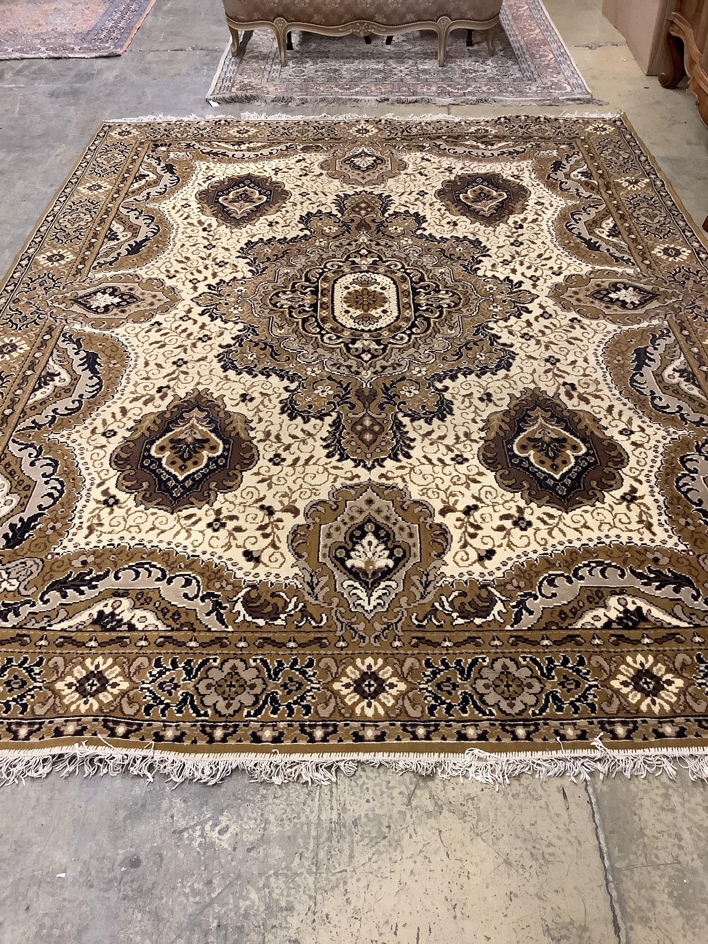 A machined Persian style ivory ground carpet, 330cm x 250cm